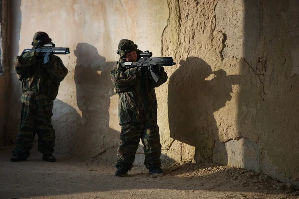 Boys playing with gun during laser tag — Stock Photo, Image