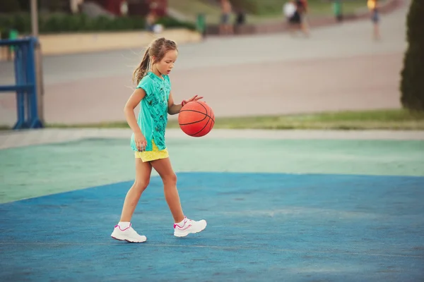 Little cute girl playing basketball outdoors — Stock Photo, Image