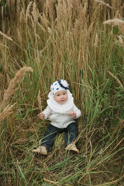 Happy little girl in high grass — Stock Photo, Image