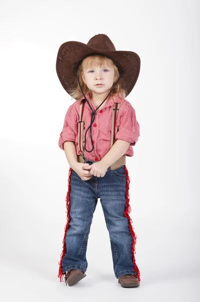 Kleine lustige Cowgirl auf weißem Hintergrund — Stockfoto