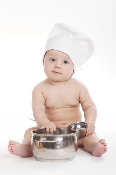 Kleine niedliche Köchin auf weißem Hintergrund — Stockfoto
