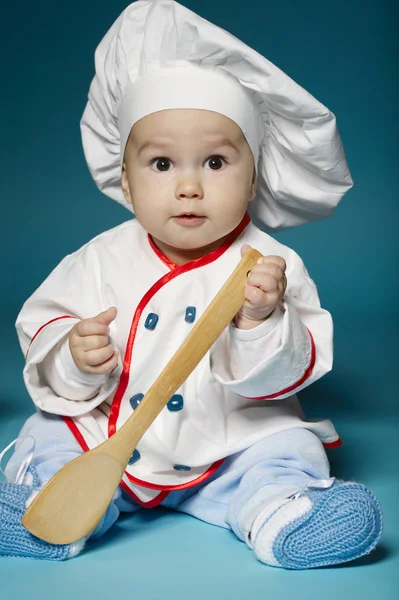 Söt liten baby med kocken hatt — Stockfoto