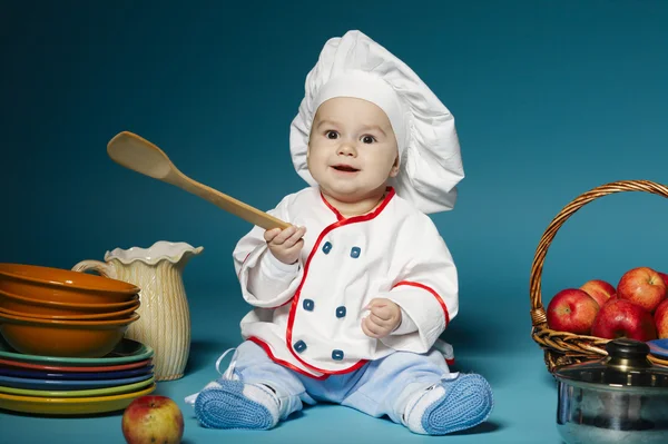 Söt liten baby med kocken hatt — Stockfoto