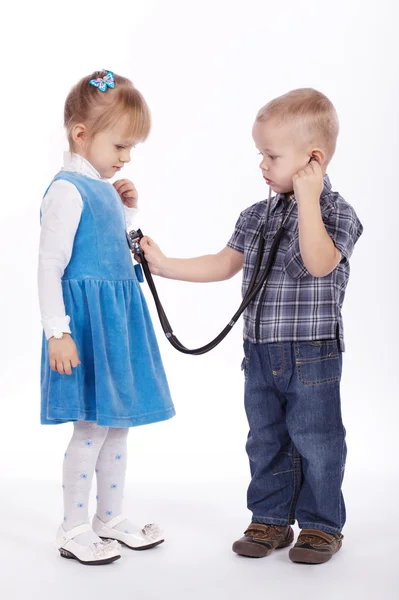 Little girl and boy playing with stethoscope Stock Picture