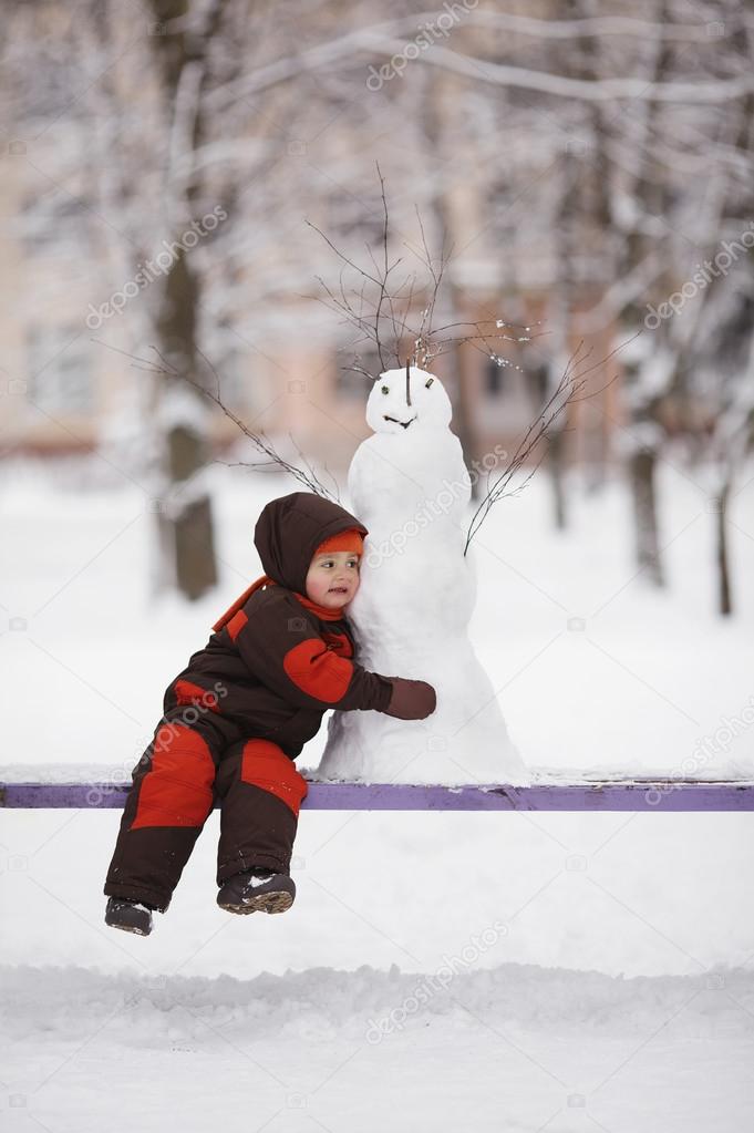 little boy with snowman