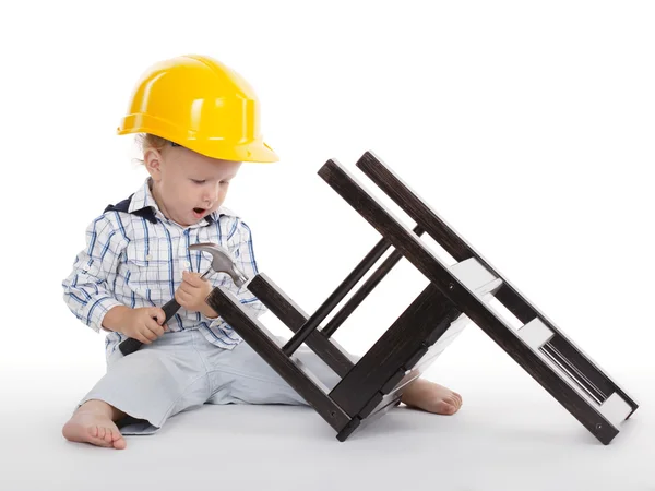 Boy repairs wooden chair — Stock Photo, Image