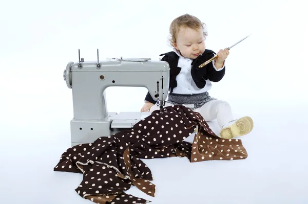 Photo of little girl with sewing machine — Stock Photo, Image