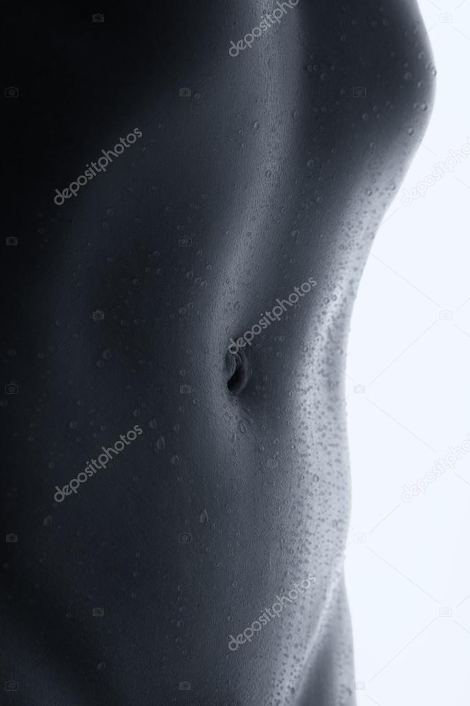 Bodyscape of a nude woman with wet stomach and back lighting art
