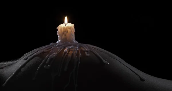 Body scape of a well-shaped woman with burning candle and wax on — Stock Photo, Image