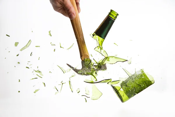 Hammer break a green glass bottle isolated on white background — Stock Photo, Image