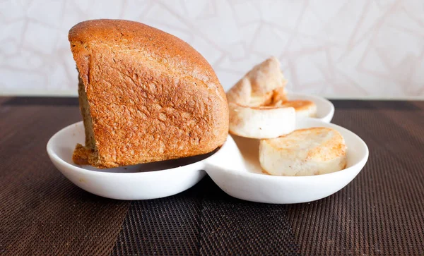 A plate with products on the table, lemon bread.