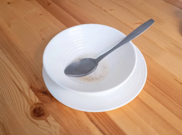 Λευκό Πιάτο Ένα Κουτάλι Στο Τραπέζι — Φωτογραφία Αρχείου