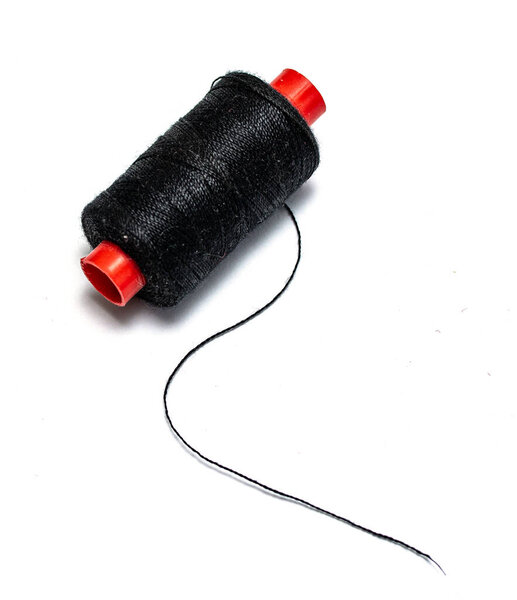 Spool of black thread on a white background.