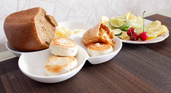 A plate with products on the table, lemon bread.