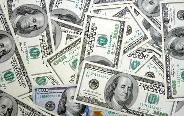 Dollar bills arranged randomly — Stock Photo, Image