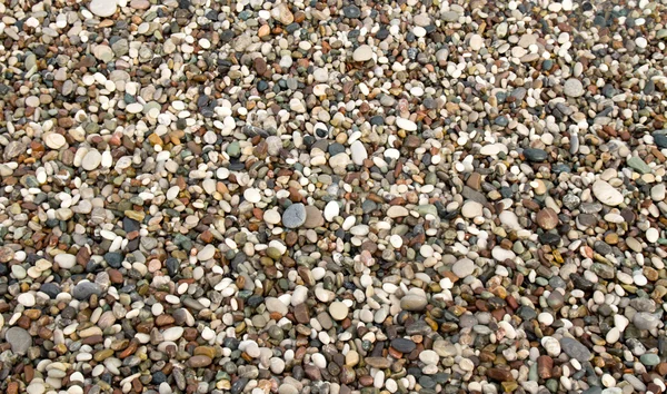 在海滩上的小石子的背景 — 图库照片