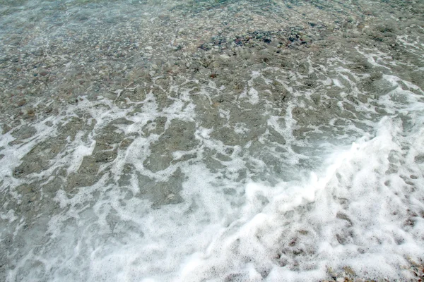 Wave foam on the beach. — Stock Photo, Image