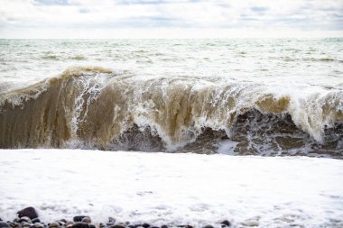 Seashore, small stones, sea wave. Marine background.