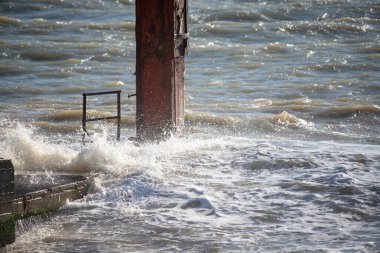 Seashore, small stones, sea wave. Marine background.