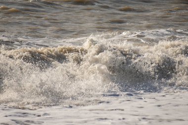 Seashore, small stones, sea wave. Marine background.