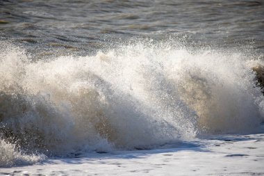 Seashore, small stones, sea wave. Marine background.