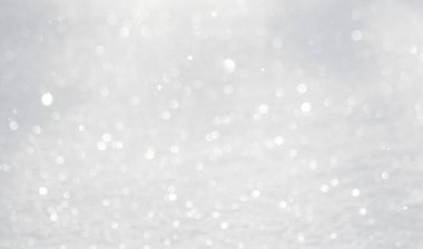 Blurred white bokeh background, snow sparkles in the sun