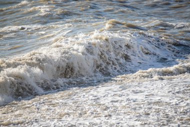 Seashore, small stones, sea wave. Marine background.