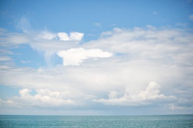 Blue sea and blue sky with white clouds. Seascape.