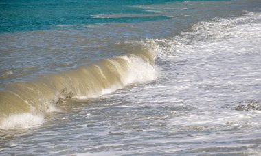 Seashore, small stones, sea wave. Marine background.