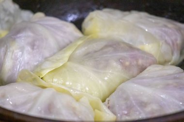 A plate of food with a variety of different shaped food items. The food items are covered in plastic wrap