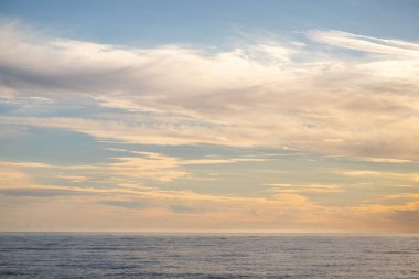 Blue sea and blue sky with white clouds. Seascape.