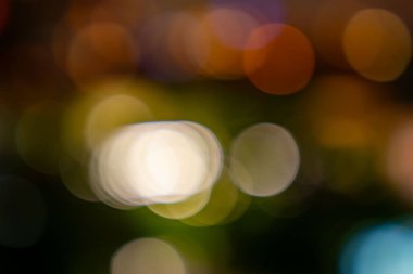 Görüntü bulanık, renkli ve soyut bir Noel ağacı tasviri. Ağaç değişik renkte çemberlerle çevrilidir. Bu da hareket ve enerji hissi yaratır.