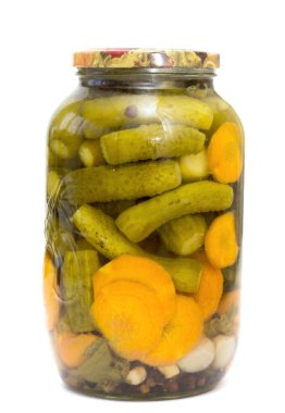 A jar of pickles and carrots. The jar is full and the pickles and carrots are visible
