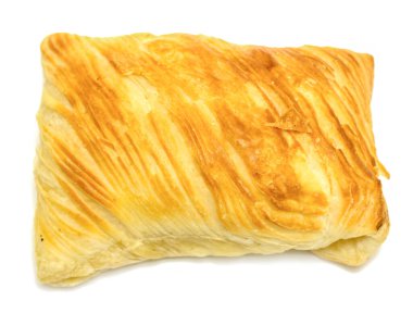 A pastry with a golden crust and a yellow filling. The pastry is sitting on a white background