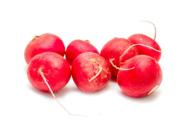 A bunch of red radishes are sitting on a white background. The radishes are all different sizes and are arranged in a row