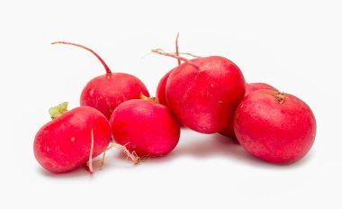 A bunch of red radishes are piled on top of each other. The radishes are small and round, with a bright red color. Concept of freshness and abundance, as the radishes are piled high
