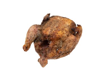 A roasted chicken with a lot of seasoning on it. The seasoning is brown and the chicken is brown as well