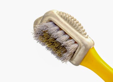 A yellow and white toothbrush with a white handle and a white and gray brush head