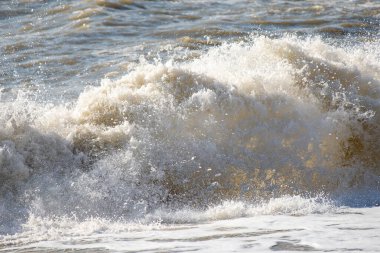 Seashore, small stones, sea wave. Marine background.