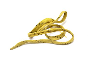 A yellow and black string is laying on a white background. The string is twisted and has a wavy pattern