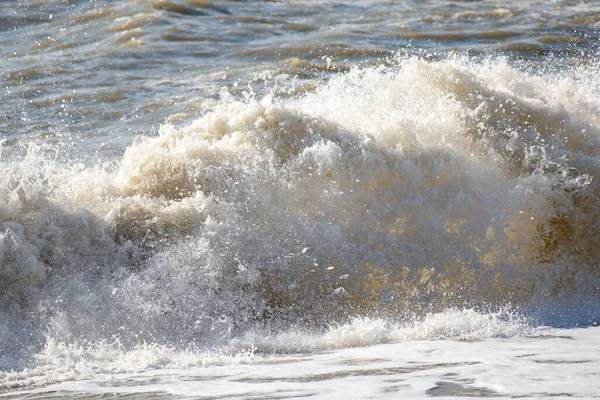 Seashore, small stones, sea wave. Marine background.