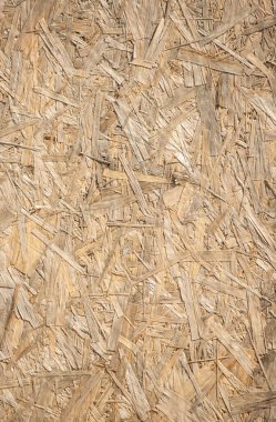 Bir sürü kıymık ve delik olan ahşap bir yüzey. Yüzey pürüzlü ve düzensiz, kırsal ve yaşlanmış bir görünüm veriyor.