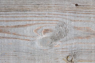 Tahta bir yüzey, kumlu bir doku ve birkaç çizik. Yüzey renk olarak aydınlık ve doğal bir hissi var.