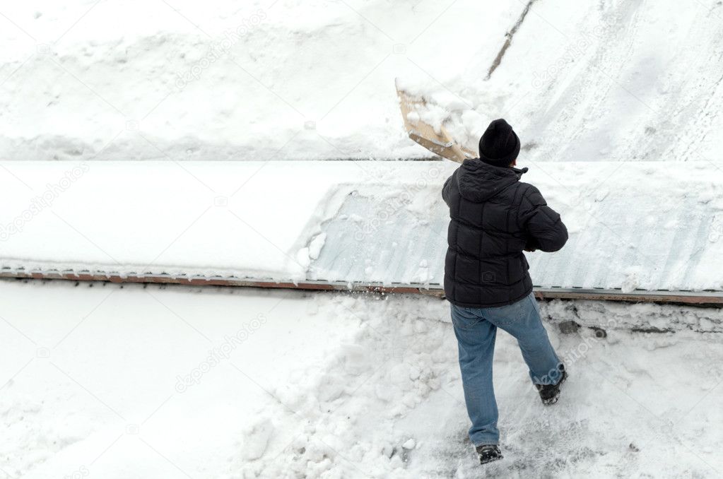 man cleans snow, top view