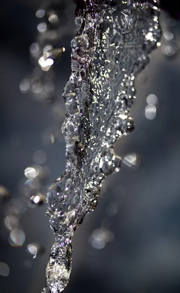 Spray water on a dark background — Stock Photo, Image