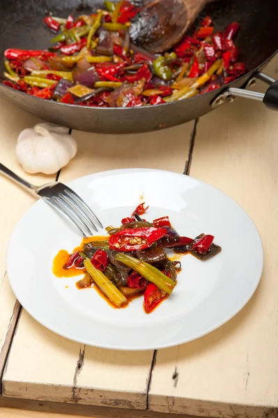 Fried chili pepper and vegetable on a wok pan — Stock Photo, Image