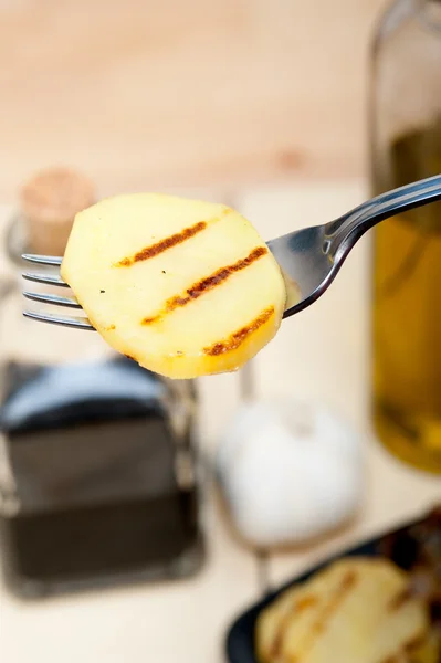 Grilled potato on a fork — Stock Photo, Image