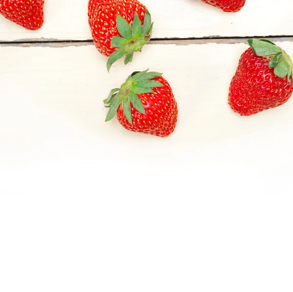 Fresh organic strawberry over white wood — Stock Photo, Image