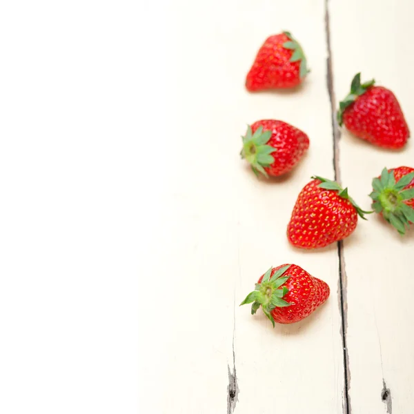 Fresh organic strawberry over white wood — Stock Photo, Image