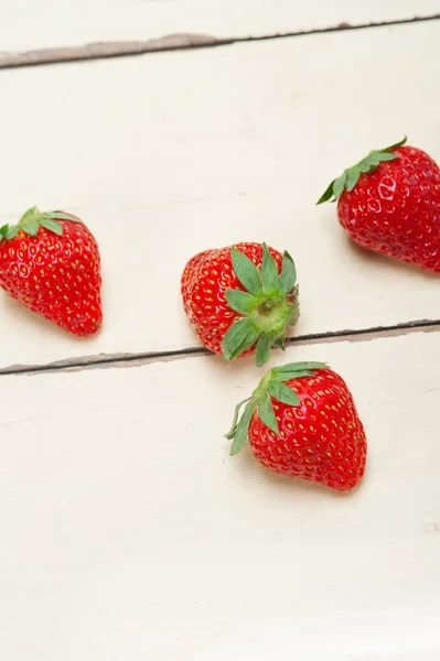 Fresh organic strawberry over white wood — Stock Photo, Image